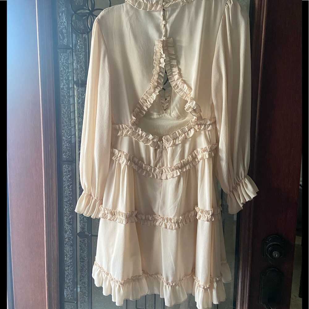 Ruffled long sleeve dress. Fits above the knee. Opened back with buttons. - Picture 2 of 2